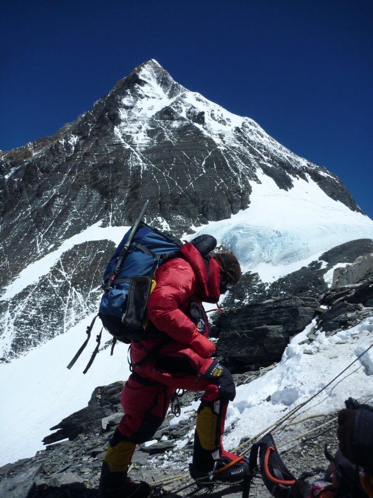 Hikers or rescuers walking on snowy mountain